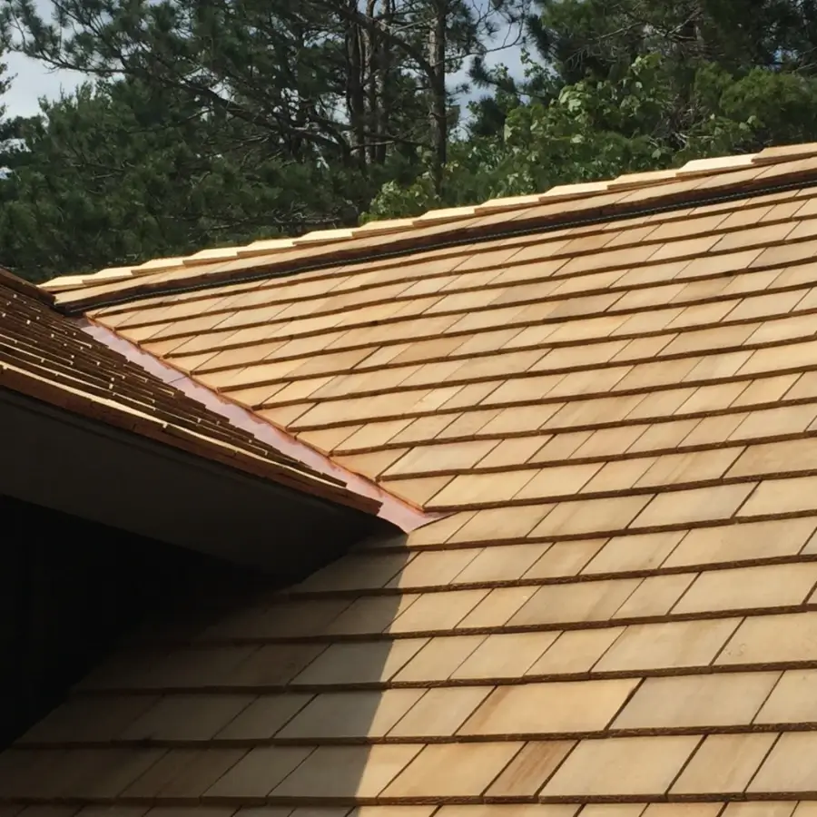 New cedar shake roof with copper valley flashing installed on cottage in Muskoka Ontario