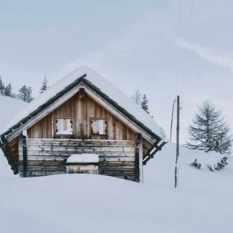Heavy snow load on wooden cottage roof during Muskoka Ontario winter