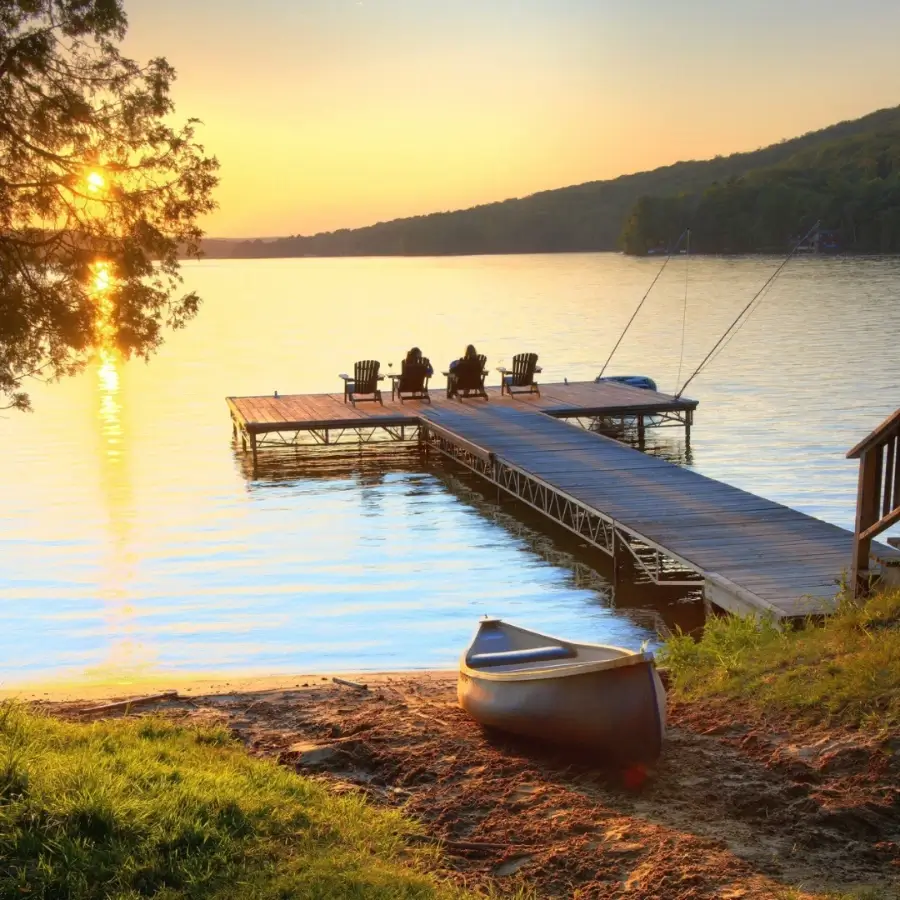 Lakefront cottage property with dock and seating area overlooking a Muskoka lake